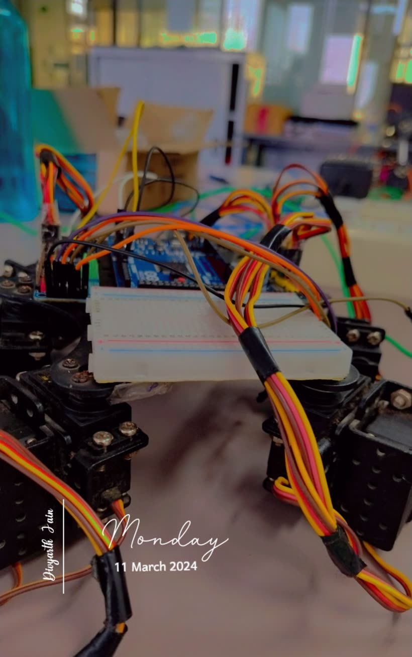 Hexapod with an Arduino on a breadboard and bundles of servo wires, dated 11 March 2024.